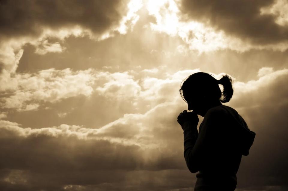 Person silhouette against clouds